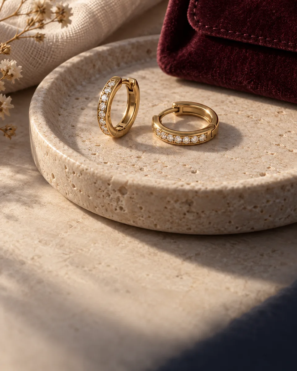 Gold and diamond earrings used in an illustrative jewellery care and customer relationship campaign